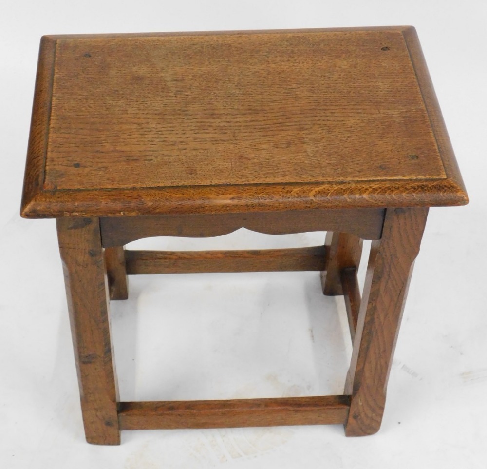 An oak rectangular joint stool with slightly splayed chamfered