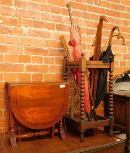 A reproduction side table, oak umbrella stand with various umbrellas and walking sticks. (a quantity)