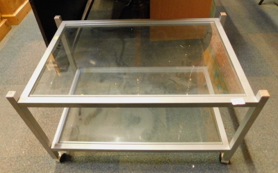 A chrome and glass two tier trolley.