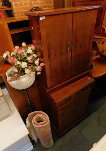 Two reproduction cabinets, a pink wool cut rug, and a jardiniere and planter.