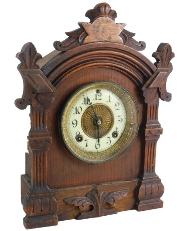 A late 19thC American Ansonia shelf clock, with eight day movement and Arabic numerals to the chapter ring, in an architectural oak case, 38cm high.