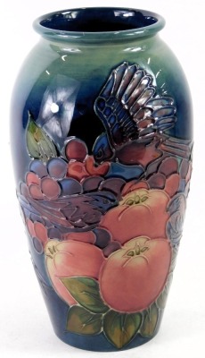 A William Moorcroft ovoid vase, on a blue ground, decorated with finches, fruits and berries, signed and stamped to underside, 19cm high. - 2