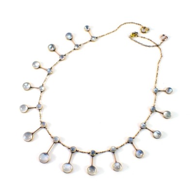 A Victorian moonstone pendant, with 15 two bar drop choker section, on yellow metal chain, with later extension, unmarked, believed to be 18ct gold, 45cm high, 14.9g all in. This pendant belonged to Lady Katherine Bosanquet, nee Carnegie, (1892-1982) and