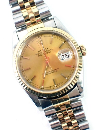 A Rolex gentleman's wristwatch in stainless steel casing, with gold outer border, with date aperture and seconds dial, lugs numbered 455B, boxed with associated paperwork, purchased from Andrew Michaels Jewellers in 2001.