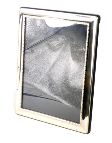 An Elizabeth II silver framed picture frame, with a beaded border, Sheffield 1995, on blue velvet lining, 24cm x 19cm.