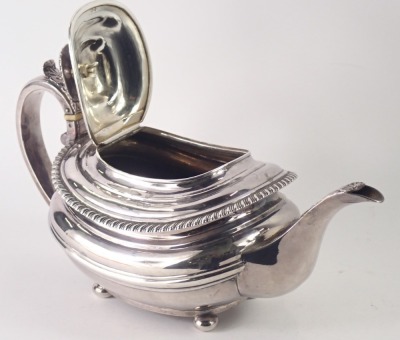 A Victorian silver teapot, with acanthus leaf handle, and rectangular rose moulded top, with a fluted border and shell capped spout, on bun feet, London hallmarks rubbed, 22.80oz. - 2