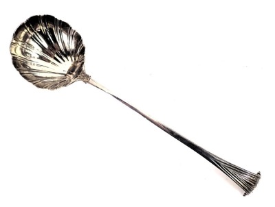 An 18thC silver serving ladle, with Onslow handle and a shell bowl, hallmarks worn, London assay, with rear initials TIB, 6oz.