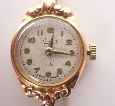 An Everite 9ct gold ladies wristwatch, with a silvered watch head in yellow metal casing, 1.5cm diameter, on three bar bracelet, 12.6g all in. - 2