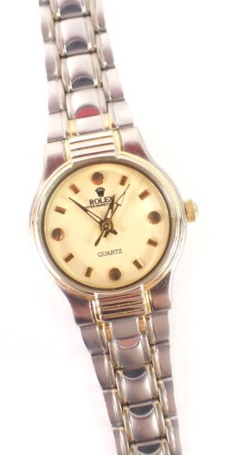 A ladies wristwatch, on stainless steel bicolour strap, with a cream coloured face, 2cm diameter.