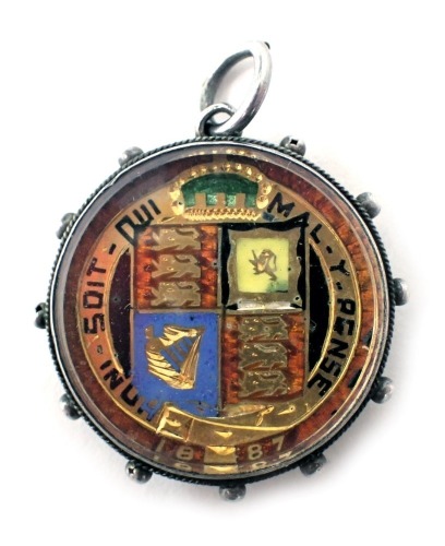 A gilt and enamelled Victorian coin, with silver pendant mount.