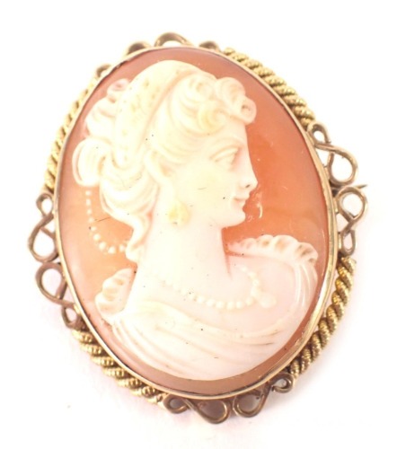 A 9ct gold framed shell cameo brooch, depicting maiden in twist and scroll outer border, 2.5cm x 2cm, 8.4g all in.