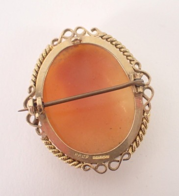 A 9ct gold framed shell cameo brooch, depicting maiden in twist and scroll outer border, 2.5cm x 2cm, 8.4g all in. - 2