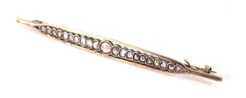 An Art Deco style bar brooch, of shaped boat form, set with diamonds, on white metal, unmarked, 9cm wide, 7.8g all in.