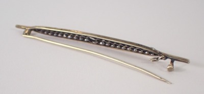 An Art Deco style bar brooch, of shaped boat form, set with diamonds, on white metal, unmarked, 9cm wide, 7.8g all in. - 2