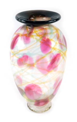 An Adam Aaronson Tin Mill Studio of London Art Glass vase, of blown internal design with yellow swirls and pink dots, on a blackened rim, signed to foot, 25cm high.