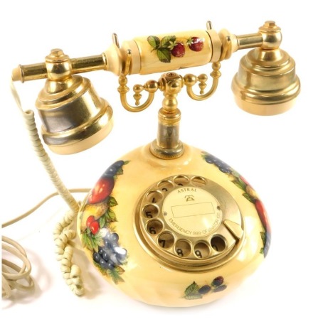 An Astral Telecoms telephone, with fruits and flowers cream design, with raised gold coloured supports, possibly Aynsley, 20cm high.