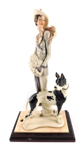 A Florence figure group of lady and dog, on mahogany rectangular base, 48cm high, 25cm wide.