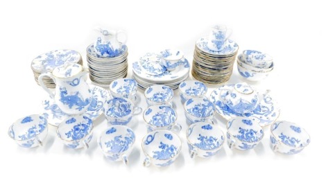 A Royal Worcester blue and white dragon pattern part service, comprising fourteen teacups, eleven saucers, two milk jugs, graduated bowls, side plates, teapot, coffee pot, matched later dinner plates, etc. (2 trays and loose) 