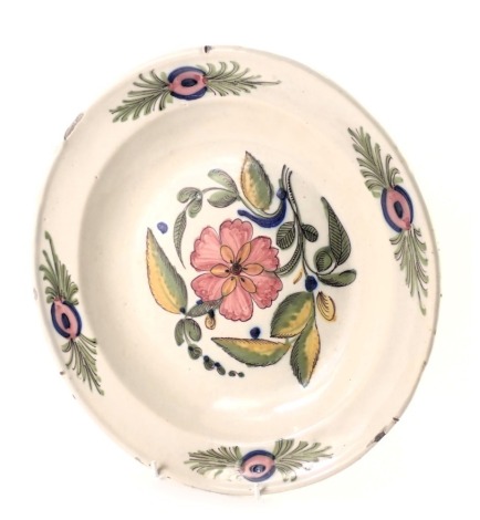 A French Faience charger, in stoneware with glazed and raised border with decoration of pink flowers, signed Vau, 31cm diameter.