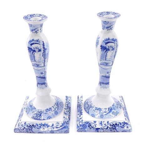 A pair of Spode Italian blue and white candlesticks, decorated with animals, figures and buildings, on a square base, 30cm high.