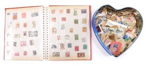 A red stamp album and contents of stamps, to include Monaco, The Netherlands, Romania, Czechoslovakia, and others, all circa 1920s-50s, and a group of lose postally worn stamps.