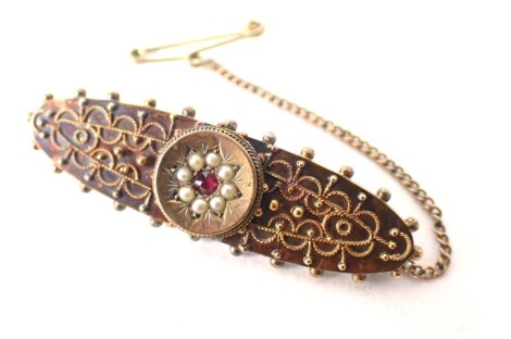 A 15ct gold bar brooch, central circular panel set with seed pearl and ruby, with filigree type decoration on single pin back with butterfly back, 4cm wide, 4.8g all in.