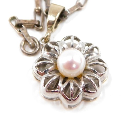 A pendant and chain, the floral pendant set with central blister pearl, and a pierced outer basket, white gold stamped 585, on a box link neck chain, white metal stamped 925, the pendant 2.5cm high, the chain 50cm long, 6.2g all in.