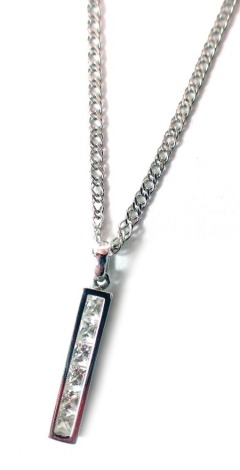 A CZ set pendant and chain, the lozenge bar set with six square cut CZ stones, in a white gold setting, unmarked, 2.5cm high, on fancy link neck chain, 44cm long, white metal stamped 585, 3.5g all in.