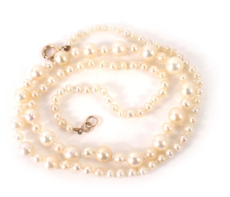 A cultured pearl necklace, of graduated design on string strand, with yellow metal clasp stamped 375, 48cm long, 10.8g all in, in Suro pearl box.