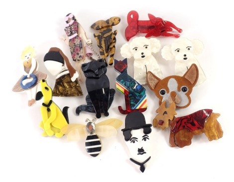 A collection of 1960s plastic brooches, to include ladies of fashion, dogs, cats, and others.