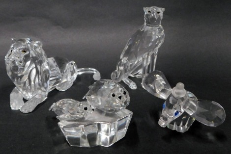 A group of Swarovski crystal animal figures, comprising Disney's Dumbo, seated ,leopard, lion, and two seals on rock. (4)