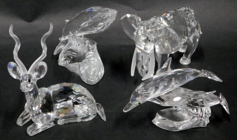 Four Swarovski crystal animal ornaments, comprising two dolphins riding wave, two whales riding wave, seated antelope, and an elephant. (4)