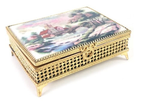 A French Limoges gilt cased rectangular box, set with Limoges panel of buildings and bridge, 4cm high, 13cm wide, 9.5cm deep. (AF)