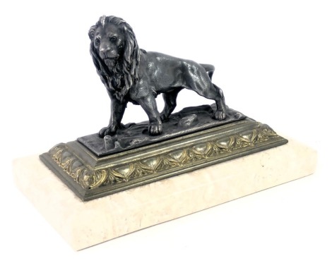 A 20thC spelter figure group, of a lion on brass and a cream marble plinth, 11cm high, 16cm wide, 9cm deep.