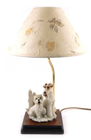 A Florence table lamp, mounted with two dogs, on a square base, with leaf moulded shade, 45cm high.