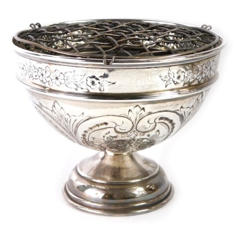 A George V silver rose bowl, embossed with flowers and rococo scrolls, maker unknown, Birmingham 1933, 11.99oz, with a metal grill insert.