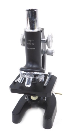 An ST microscope, 32X-1200X, with additional lenses, capsules, and slides, boxed.