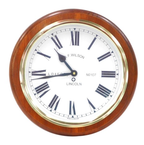 An AF Wilson replica circular oak cased railway wall clock, the dial bearing Roman numerals, and L.D&E.C.RLY. number 107, Lincoln, battery movement, 34cm wide.