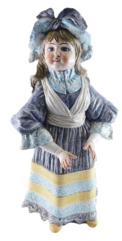 A painted continental ceramic figure, of a child wearing grey and yellow dress with lace borders and a bonnet, 73cm high.