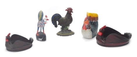 A cast iron cockerel door stop, 34cm high, painted plaster figure of a chicken, wooden figure of a chicken, and two cane work trays, or baskets, models as chickens, 41cm wide and 29cm wide respectively. (5)