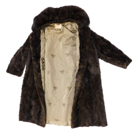 A Shillington Furs full length brown fur coat, bearing labels.