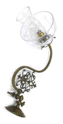 A Victorian brass wall mounted oil lamp, of bracket form, converted for electricity with funnel and cut glass shade.