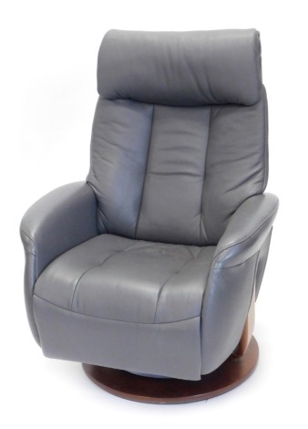 A Sitbest grey leather electric revolving adjustable armchair, with power supply.