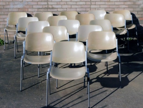 Seventeen DEC Castelli stacking chairs, with part aluminium framing and reformed seats and backs.