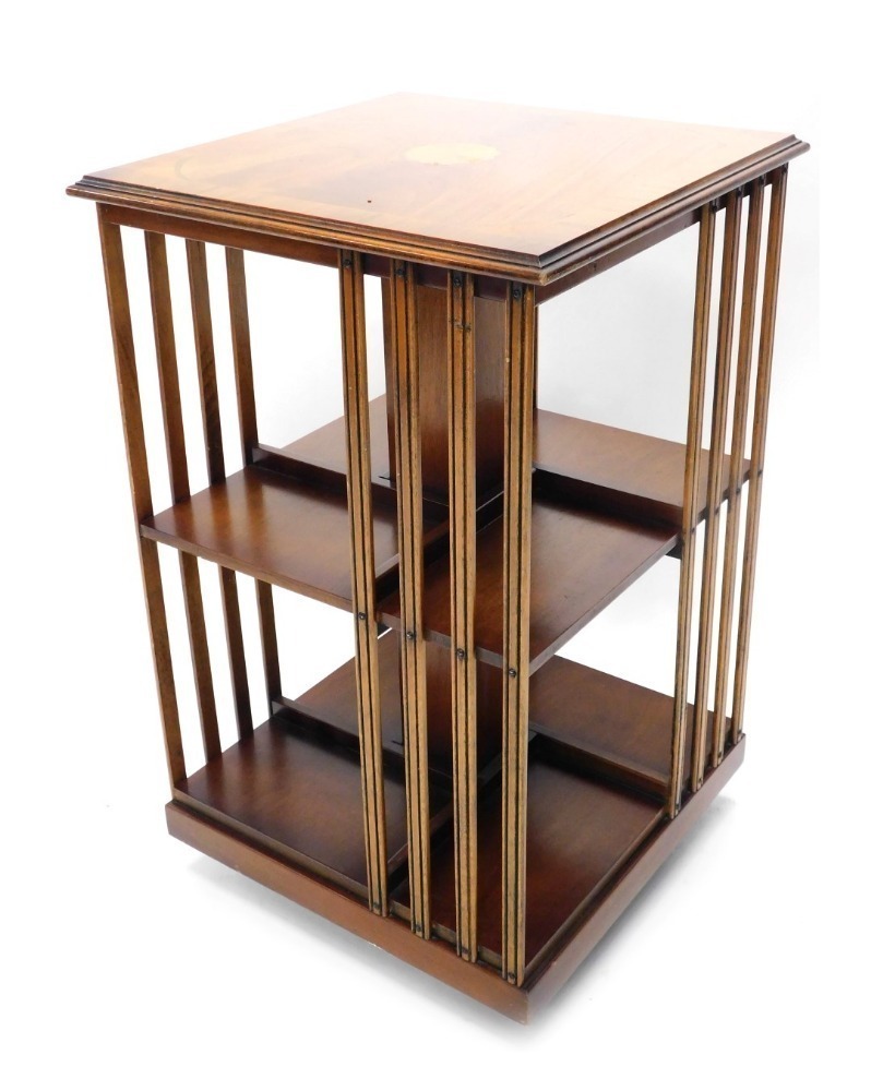 A reproduction Edwardian cross banded and inlaid revolving bookcase.