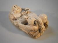 A simulated ivory figure group of Hotei with children