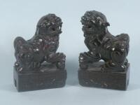 A pair of 19thC carved mahogany Shi-Shi figures with keyed bases