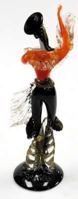 A Murano glass figure of a male Flamenco dancer, modelled standing, in orange and black, on a circular base, 47cm high. - 2