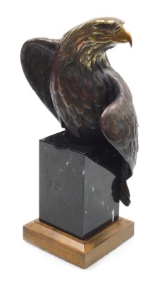 An American bronze of a bald eagle "Vigilance", modelled by Doctor Robert Taylor, perched on a black marble block, and oak plinth, signed and titled, 40cm high.