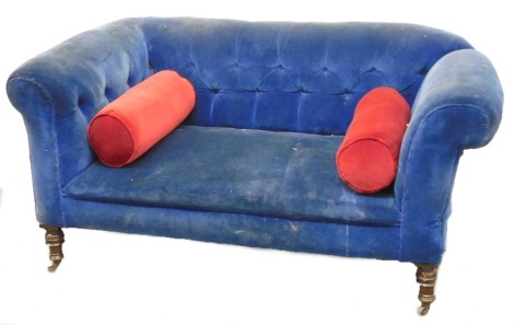 A Victorian mahogany two seater sofa, upholstered in blue button back draylon, raised on turned legs, on castors, 153cm wide.